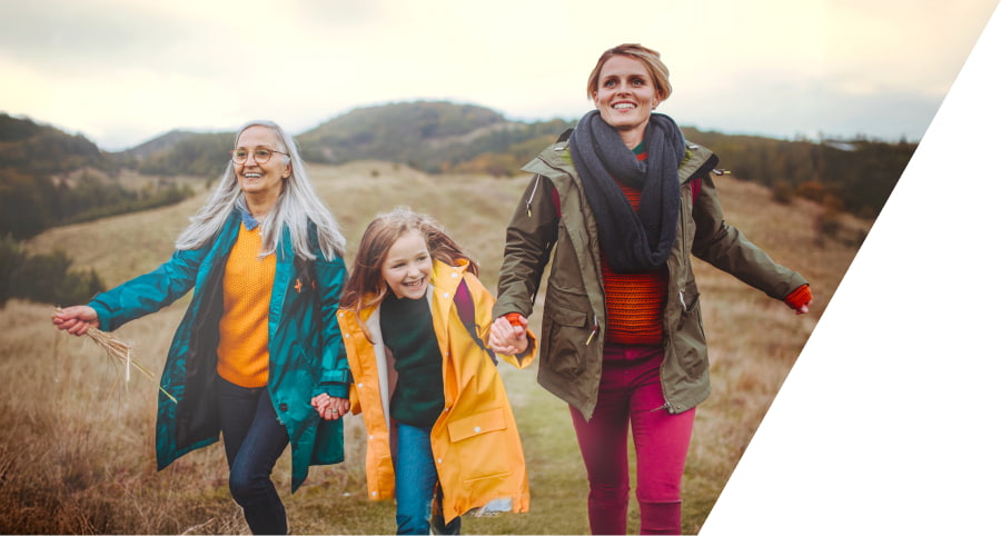 Grandmother, Daughter, and Grandchild running in field